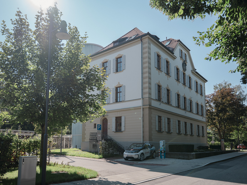 Verwaltungsgebäude Am Klafferer in Bad Aibling. Davor ein Carsharing Elektroauto.